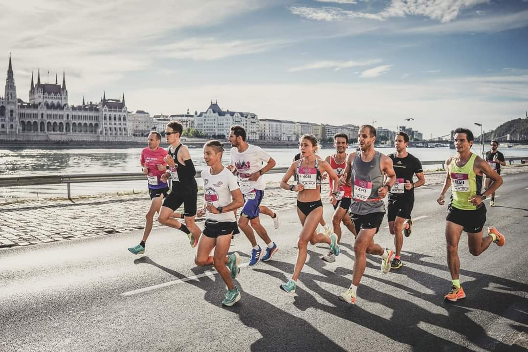 Marathon runners racing along the Danube in front of the Hungarian Parliament in Budapest